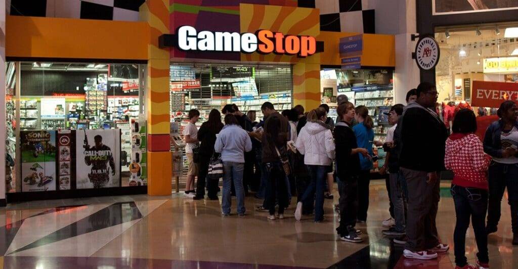 GameStop storefront with a crowd of customers in a shopping mall setting.